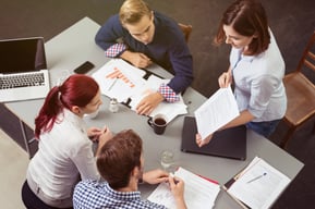 people working on a lean manufacturing project at a table