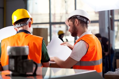 Male factory worker and supervisor are analyzing plans-2