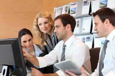 Business meeting in front of desktop computer