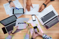 Business people using mobile phones and laptops, calculating and discussing <a href=