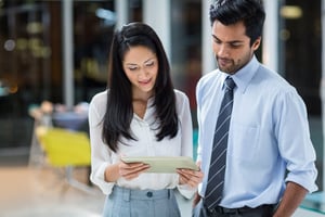 Businesswoman and colleague looking at digital tablet in the office.jpeg