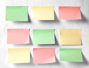 Colourful sticky notes on a white wall.jpeg
