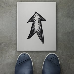 Hand drawn arrow design doodle icon on front of business man feet as concept .jpeg