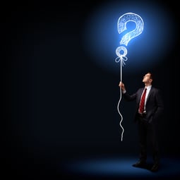 Image of businessman in black suit against dark background