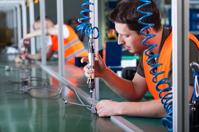 Men during precision work on production line, horizontal-1