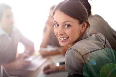 Portrait of smiling working girl in meeting