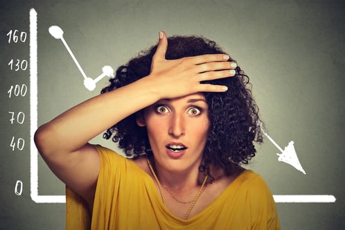 Stressed shocked woman with financial market chart graphic going down on grey office wall background. Poor economy concept. Face expression, emotion, reaction.jpeg