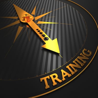 Training - Business Background. Golden Compass Needle on a Black Field Pointing to the Word "Training". 3D Render.