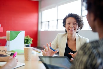 Unposed group of creative business people in an open concept office brainstorming their next project..jpeg