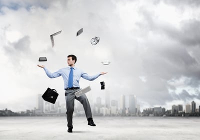 Young businessman juggling with business items against urban scene