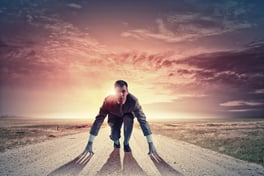 Young determined businessman standing in start position