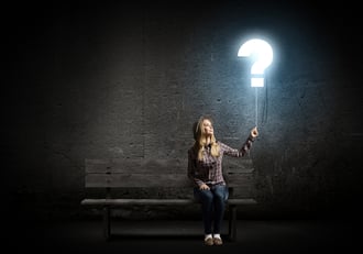 Young woman in casual holding balloon shaped like question mark-2