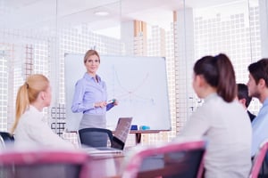 business woman  with her staff,  people group in background at modern bright office indoors.jpeg