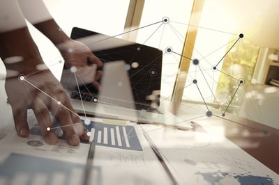 double exposure of business documents on office table with laptop computer and man working in the background and social network diagram