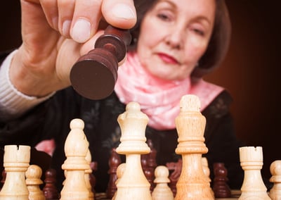 business woman making a move in a chess game