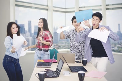 Employees dancing in office.